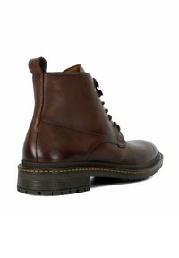 Brown leather ankle boot with a rounded toe, lace closure, and a sturdy rubber sole. Features contrast stitching and a pull tab at the back.
