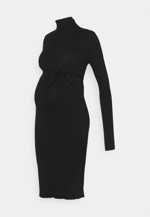 Zwart langemouw zwangerschapsjurk met een col en een gestrikt taille-detail. Gemaakt van zachte, rekbare stof. Knielange silhouet.