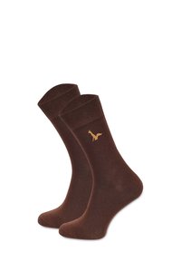 Brązowe skarpetki bawełniane z prążkowanymi mankietami, z złotym emblematem lisa z boku. Gładka faktura i długość do kostki.