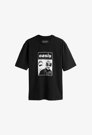 Svart bomulls t-shirt med ett grafiskt tryck av två figurer i monokromt med texten "oasis" ovanför i en fet rektangulär ram.