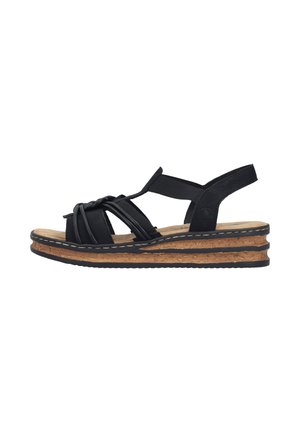 Sandale compensée en cuir noir avec brides nouées, bout ouvert et semelle en liège avec bordure noire, vue de l'extérieur.