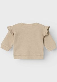Maglione beige a coste con spalle volant, maniche lunghe e scollatura rotonda. Texture morbida e polsini e orlo aderenti.