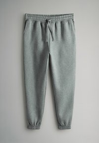 Pelēki sporta bikses no mīksta auduma ar elastīgu jostasvietu un šņorēšanu, ar piedurknēm un sānu kabatām.