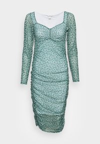 Vestido de malha verde de mangas compridas com padrão floral branco. Apresenta detalhes franzidos por todo o vestido e um decote quadrado.