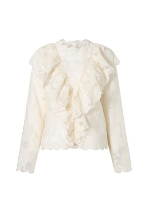 Bluza de dantelă ivoire cu mâneci lungi, margini ondulate și detalii cu volane suprapuse pe față și umeri.