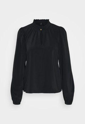 Blouse noire en tissu doux avec un col froncé haut, une ouverture en forme de clé à l'avant, et de longues manches bouffantes avec des poignets ajustés.