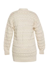 Pulover tricotat de culoare crem, cu un design texturat și cu modele, având guler și manșete cu nervuri. Mâneci lungi, pe o lungime medie.
