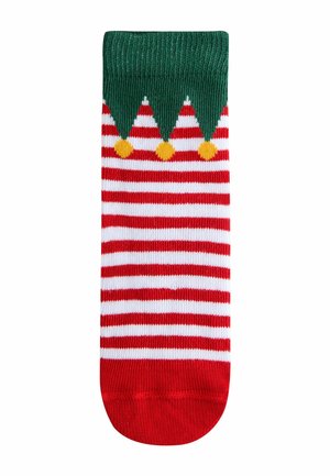 Röd och vit randig strumpa med grön topp som har triangulära detaljer och gula pom-poms. Tillverkad av mjukt, stretchy material.