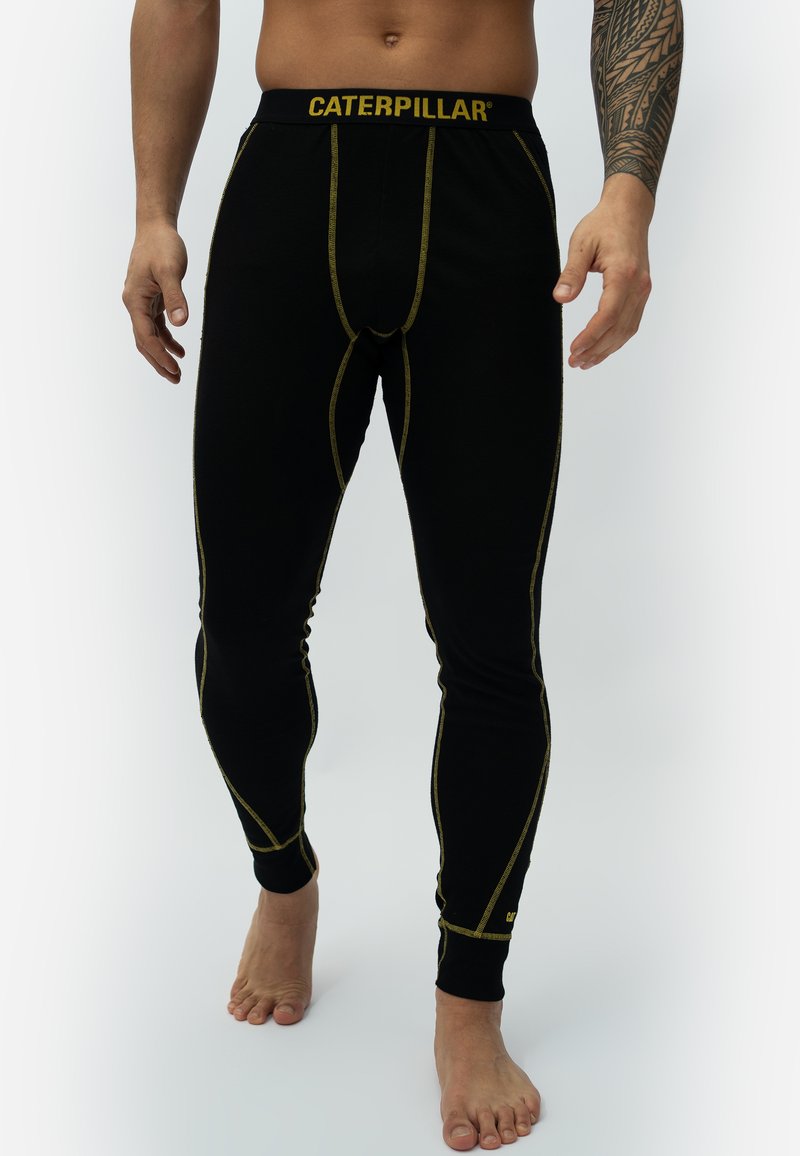 Black thermal leggings with yellow stitching and a yellow "CATERPILLAR" logo on the waistband. Fitted design with a smooth texture.