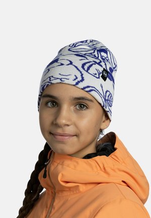 Knit beanie in white with blue abstract patterns, featuring a black logo tag. Worn by a child in an orange jacket with a hood.