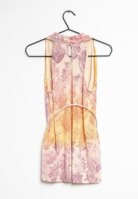 Vestido sin mangas en un perchero negro, con un estampado de paisley en rosa y naranja. Tejido suave, escote alto con un detalle de abertura en la parte posterior.