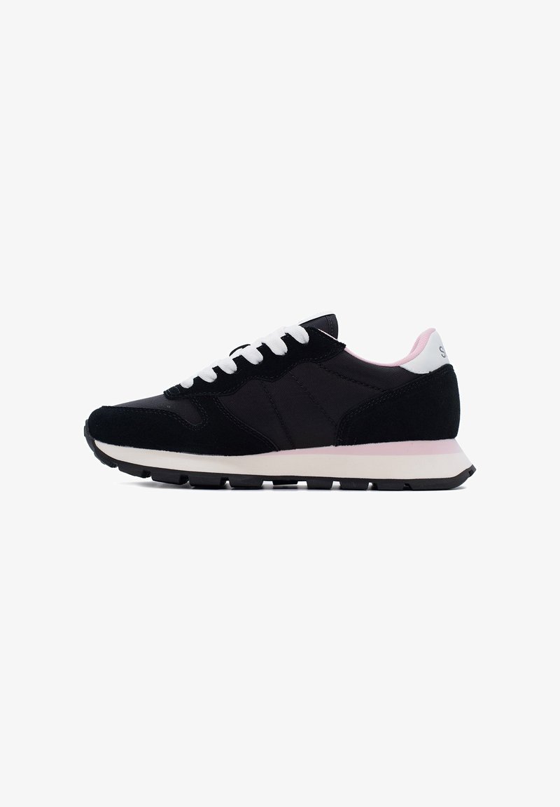 Black athletic shoe with a suede and fabric upper, white laces, pink heel accent, and a white midsole with a black rubber outsole.