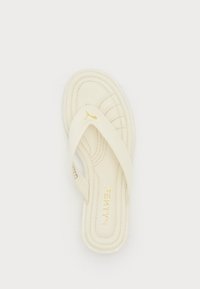 Cream-colored thong sandal with gold Puma logo on strap and "FENTY" branded in gold on footbed, visible stitching details.