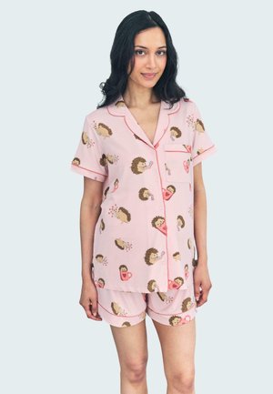 Roze pyjama set met een egelpatroon, gemaakt van zachte stof met rode details. Bevat een top met korte mouwen en knopen en een short.