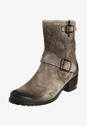 Gray suede ankle boot with floral embossed pattern, adjustable strap and buckle, rounded toe, and stacked heel. Textured finish.
