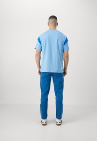 Puma MANCHESTER CITY FTBLARCHIVE - Pantaloni sportivi - lake blue/racing blue