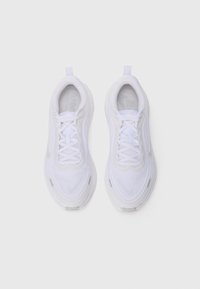 Pair of white Nike running shoes with laces, mesh upper, and a pull tab at the heel on a plain white background.