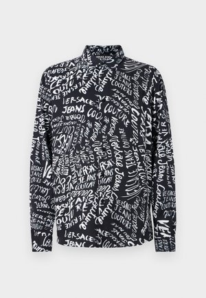 Black long-sleeve shirt with white "Versace Jeans Couture" text in various fonts and sizes, featuring a high collar and relaxed fit.