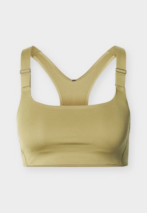 Brassière de sport vert olive clair avec bretelles réglables et design dos nageur sur un fond uni.