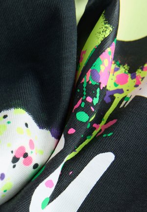 Mehrfarbiger Stoff mit einer Mischung aus schwarzen, weißen und grellen Neon-Spritzmustern, mit strukturierter Oberfläche und glattem Finish.