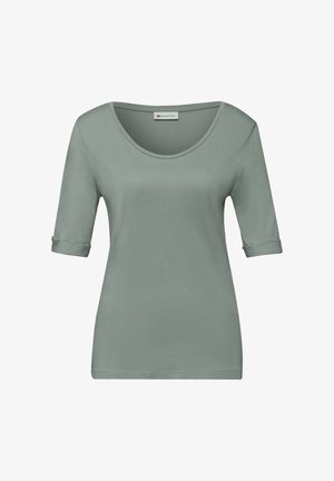 Chemise verte sauge pour femmes à manches courtes avec encolure dégagée et manches retroussées, étiquetée "Street One" à l'intérieur du col.