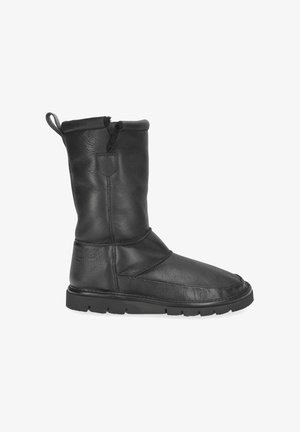 Schwarzer Lederstiefel bis zur Mitte der Wade mit Zuglasche, abgerundetem Zehenbereich, mehrlagiger Naht und dicker Gummisohle, seitlich auf weißem Hintergrund dargestellt.