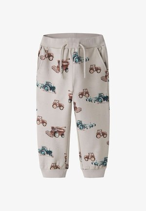 Beige joggers til småbørn med elastisk talje og manchetter, med print af blå og brune traktorer og landbrugsmaskiner.