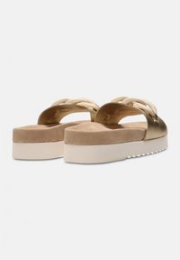 Gold metallic platform sandals with a wide cross-strap design and a soft beige suede footbed. Features a textured white outsole.