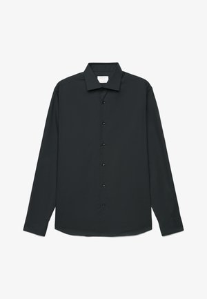 Chemise noire à manches longues avec col classique, six boutons avant et ourlet droit, présentée à plat sur un fond blanc.