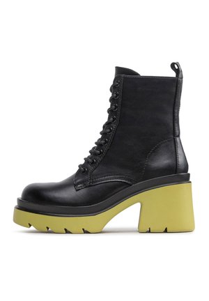 Black leather lace-up ankle boot with thick yellow chunky heel and treaded sole, side view on white background.