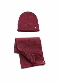Burgundy knit beanie with folded cuff and matching scarf. Both have ribbed texture and a small metal logo accent on the scarf.