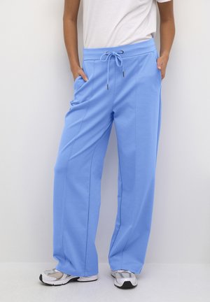Hellblaue, lockere Sweatpants mit elastischem Bund, verstellbarem Kordelzug, seitlichen Taschen und glatter Textur.