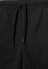 Pantalon en tissu noir avec une taille élastique et des cordons noirs noués en un nœud à l'avant-centre.