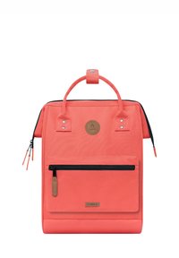Coral backpack with a structured design, zippered front pocket, and two top handles. Features a round logo and contrasting black zippers.