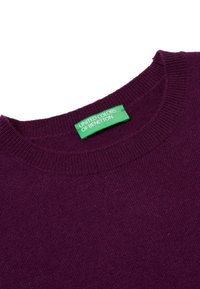 Purple knit sweater with a round neckline, featuring a green label that reads "UNITED COLORS OF BENETTON." Soft texture and streamlined design.