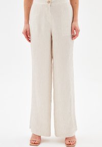 Light-colored, striped trousers with a wide-leg design, featuring a button closure and smooth texture.