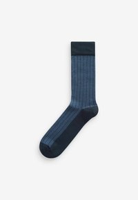 Navy socks featuring a herringbone pattern in a lighter blue. Smooth texture with a ribbed cuff at the top. Classic design.
