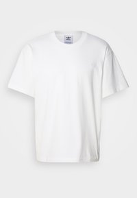 White cotton t-shirt with short sleeves and a round neck. Features a small, embroidered logo on the left chest, offering a classic design.