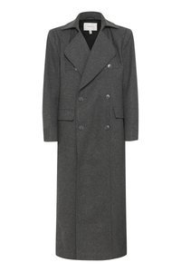 Hallhallane villane trench-coat topeltrinde ja suurte kraedega, kahe esisegmendiga ning pika, sirge lõikega. Matt nupud tooni aksessuaarid.