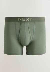 Miesten vihreät bokserit ommelluilla paneeleilla ja joustavalla vyötärönauhalla, jossa lukee vaalealla kirjaisulla "NEXT".