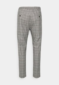 Grå rutiga byxor med elastisk midja, två bakfickor och en slim fit-design. Har tunna bruna linjer i det rutiga mönstret.