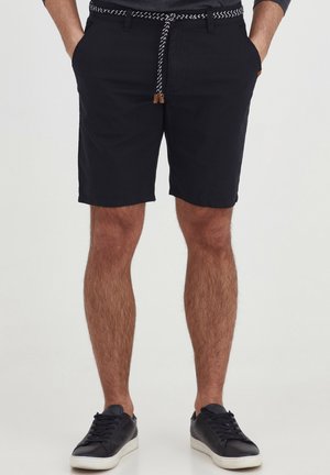 Sorte, knælange shorts i bomuld med en vævet snor i taljen, der har et kontrasterende mønster. Inkluderer forlommer.