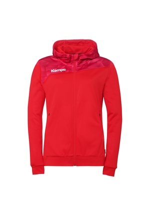 Veste rouge à capuche avec fermeture éclair complète, manches longues, empiècement à motifs, poches latérales et logo blanc "Kempa" sur la poitrine.