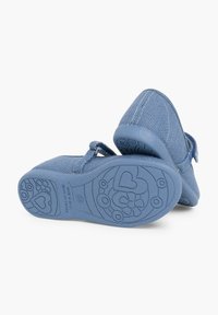 Niebieskie buty z materiału z teksturowanym wzorem, zaokrąglonym noskiem i regulowanym zapięciem. Podeszwy mają kwiatowe i sercowe wzory w dopasowanej tonacji.