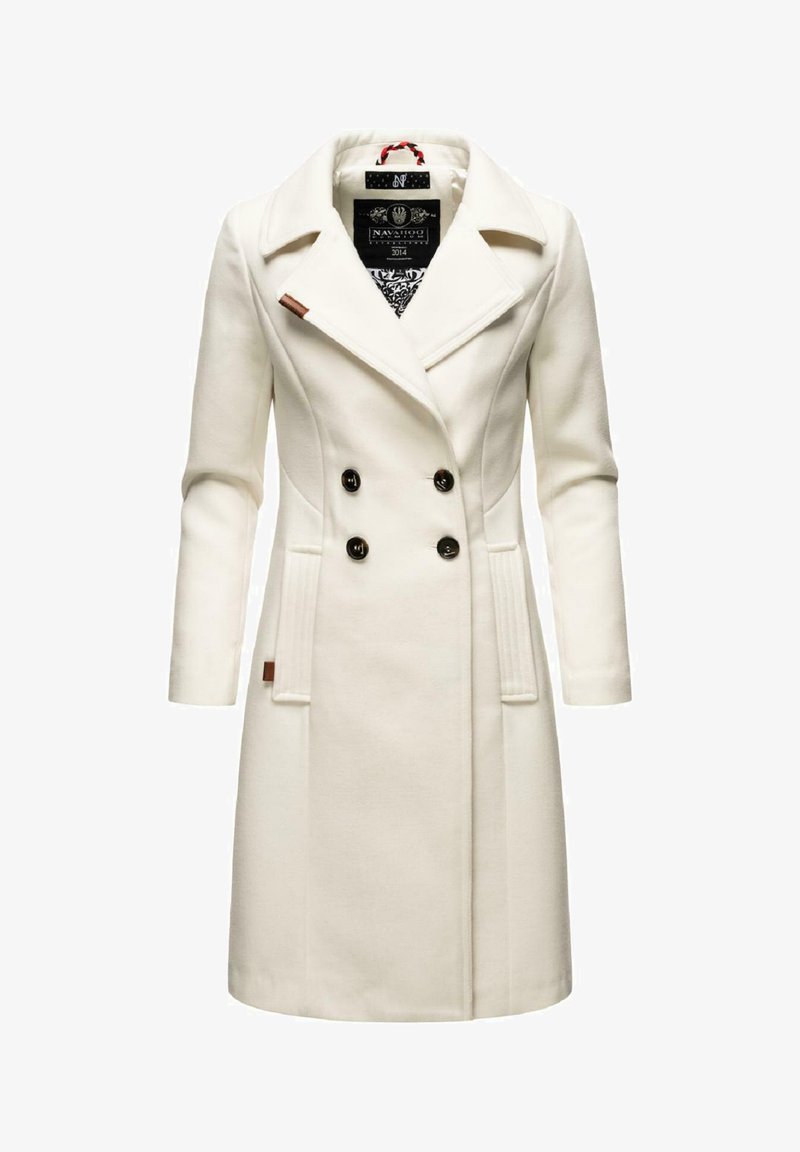 White double-breasted coat featuring a peak lapel, black buttons, side pockets, and a textured fabric with a slightly tailored fit.