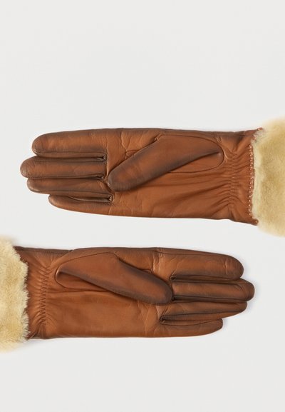 Καφέ δερμάτινα γάντια με απαλό ταμπά μάλλινο επένδυση και ελαστικό καρπό. Διαθέτουν ομαλή υφή και καμπυλωτές ραφές για λεπτομέρεια.