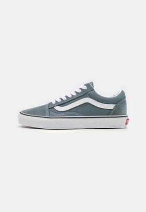 Low-top gray-blue sneaker with white laces, white side stripe, and thick white sole, positioned in profile on a plain background.