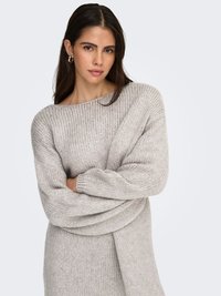 Light gray oversized sweater with a wide neckline and long sleeves, made from a soft, chunky knit material. Features a relaxed fit.