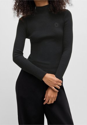 Stickad tröja - black