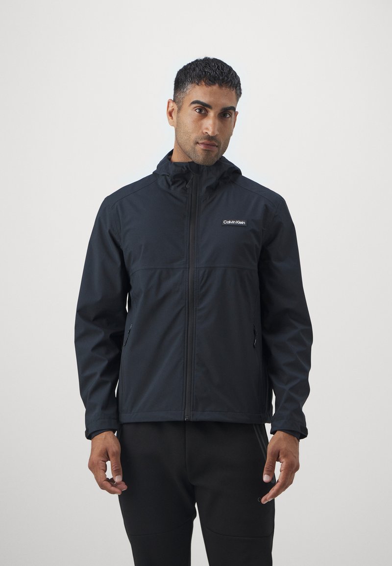 Calvin Klein Golf FEATHER DRY WATERPROOF SHELL JACKET - Regnjakke - black